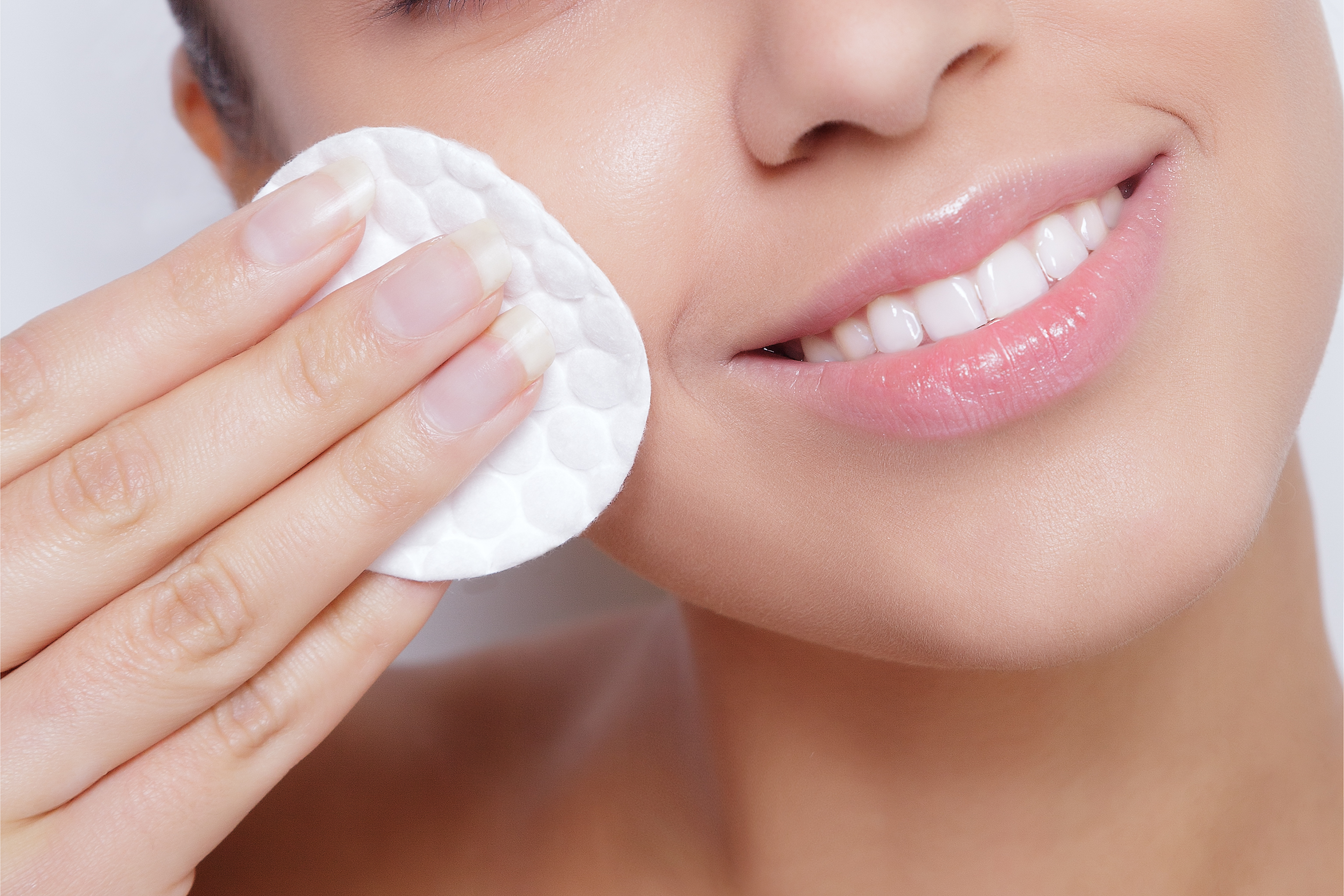 a woman removing makeup